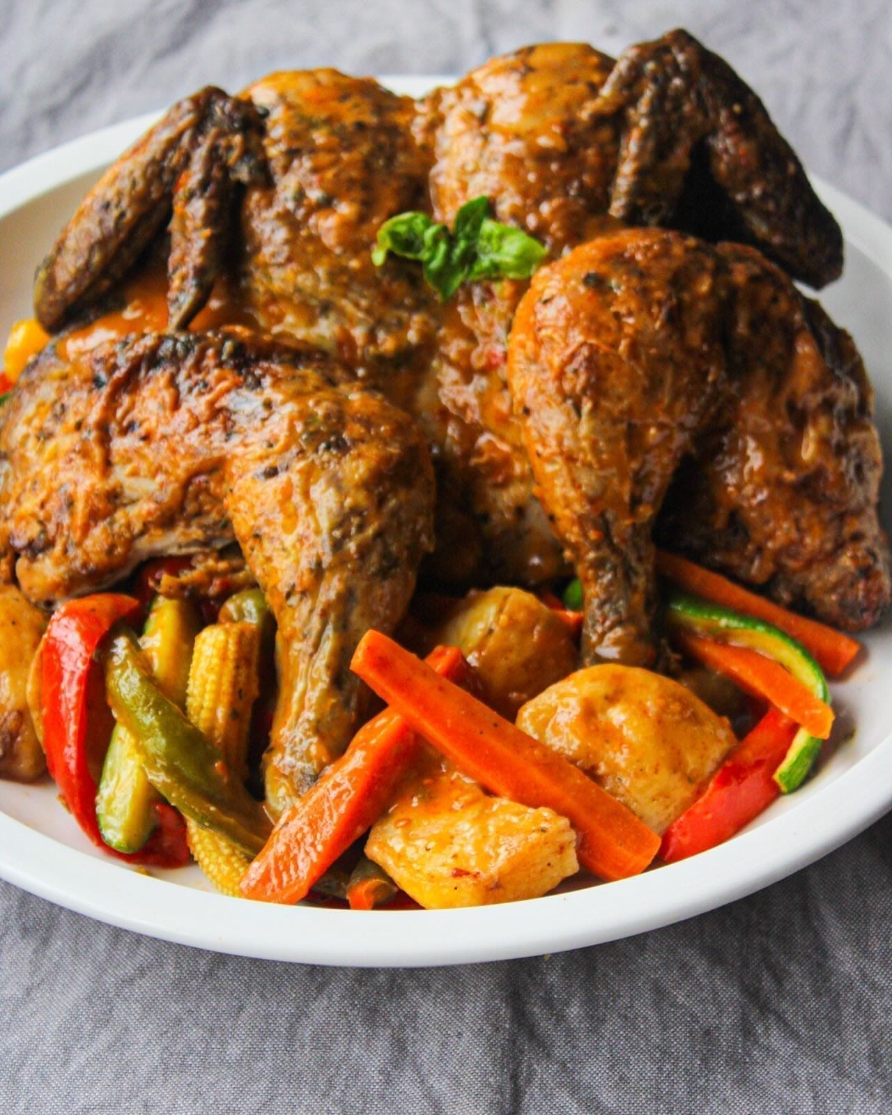 Roasted quartered chicken plated with glazed vegetables for Country Choice Chicken