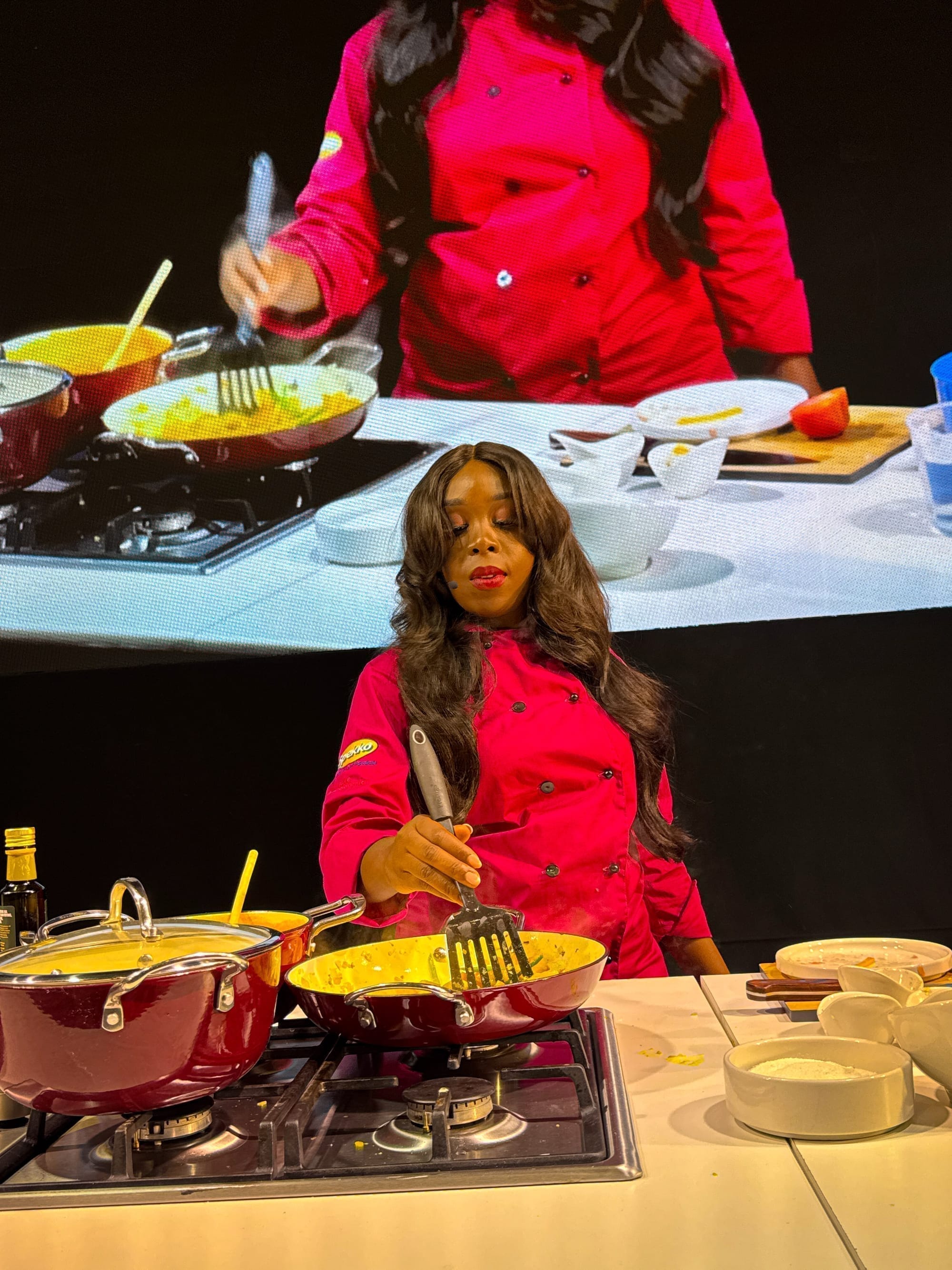 Clara Kapelembe Bwali cooking live, relayed on the venue's screen at the Good Life Show