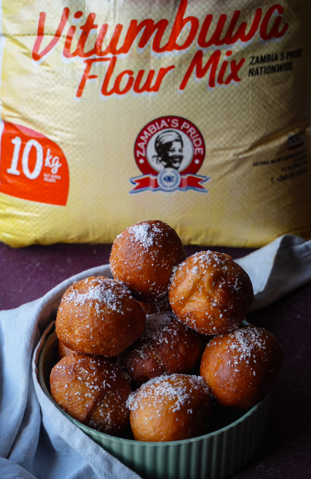 Coconut-dusted doughnuts styled with Zambia's Pride Vitumbuwa flour mix packaging